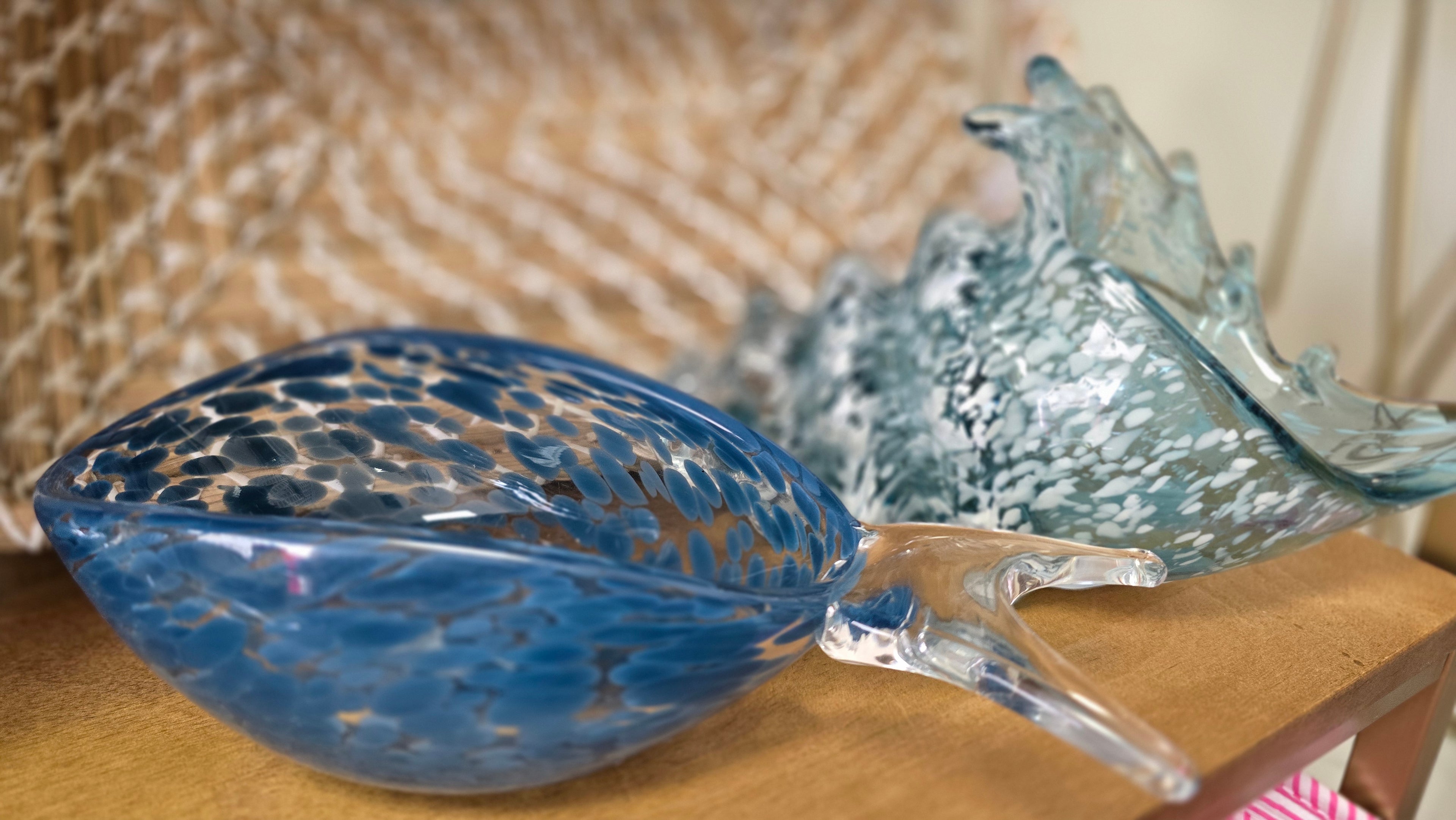 Decorative glass bowl with blue and clear design on a wooden surface